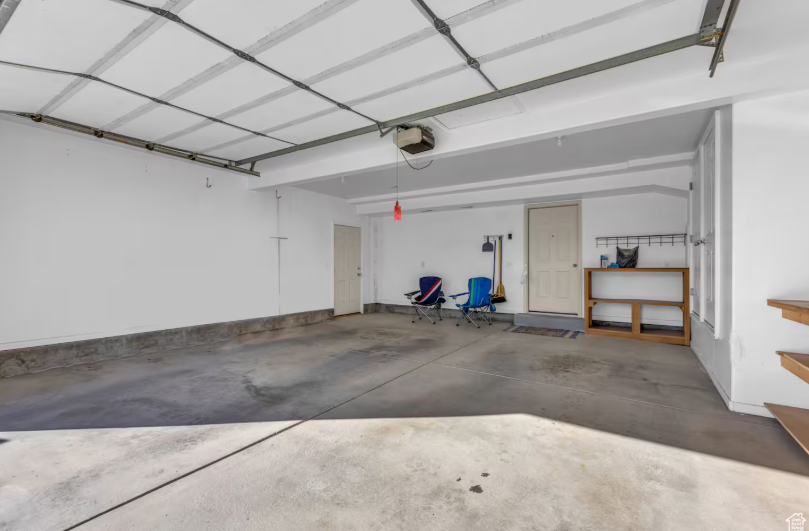 Spacious 2-car garage with concrete floor, automatic door opener and interior access door