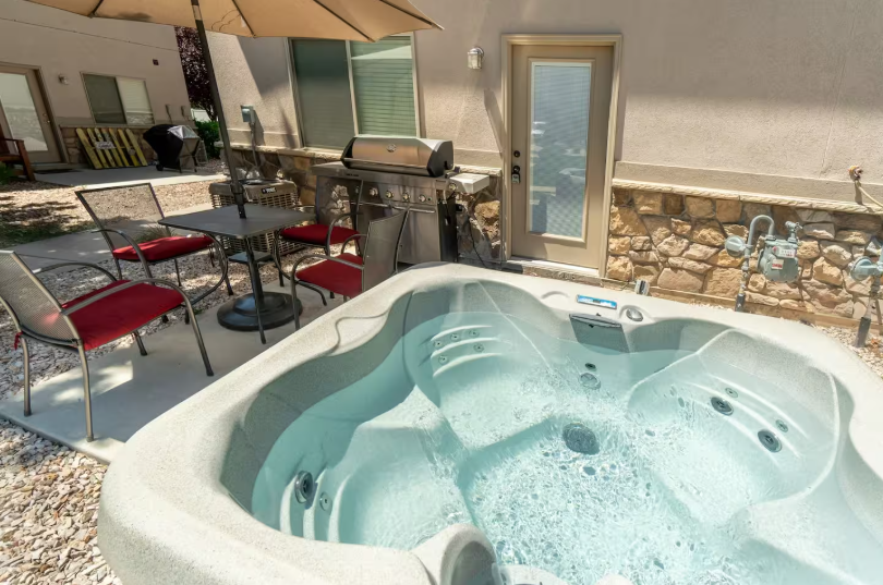 Private back patio with bubbling hot tub, BBQ grill and outdoor seating
