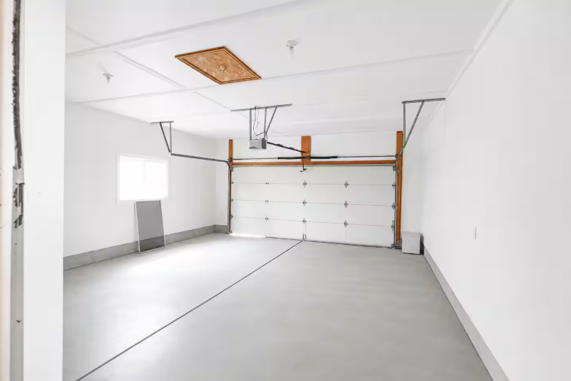 Spacious 2-car garage with epoxy-coated floor, automatic garage door opener and attic access hatch